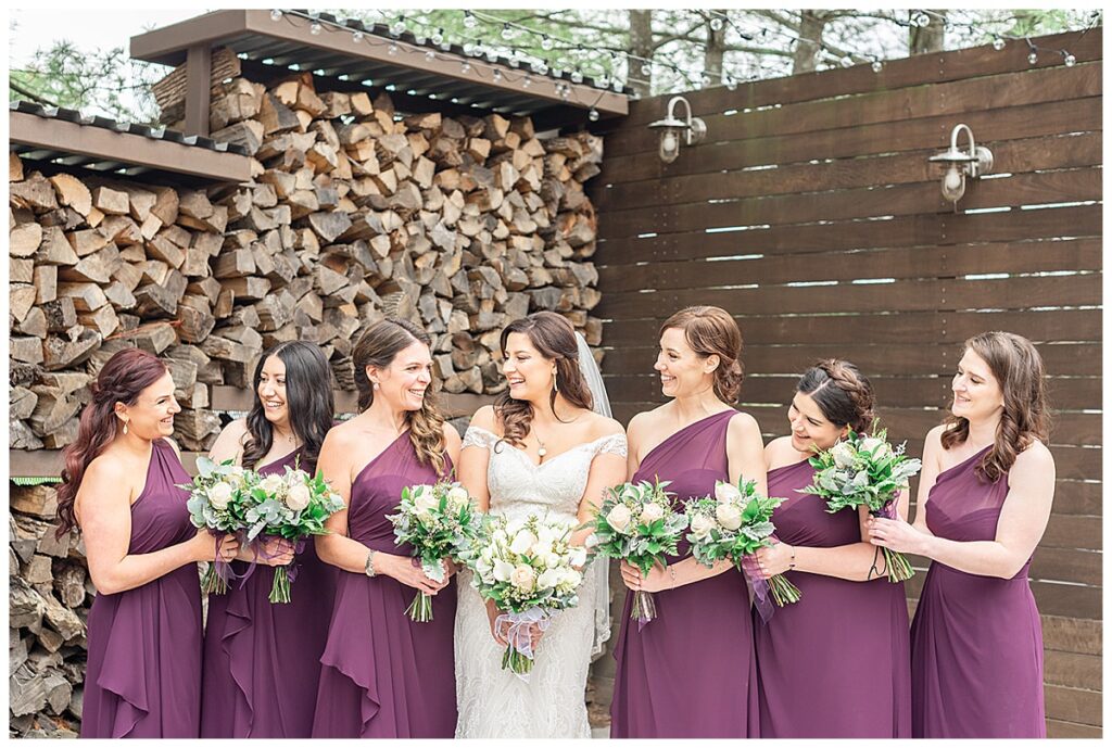 bridesmaids in eggplant one shoulder dresses