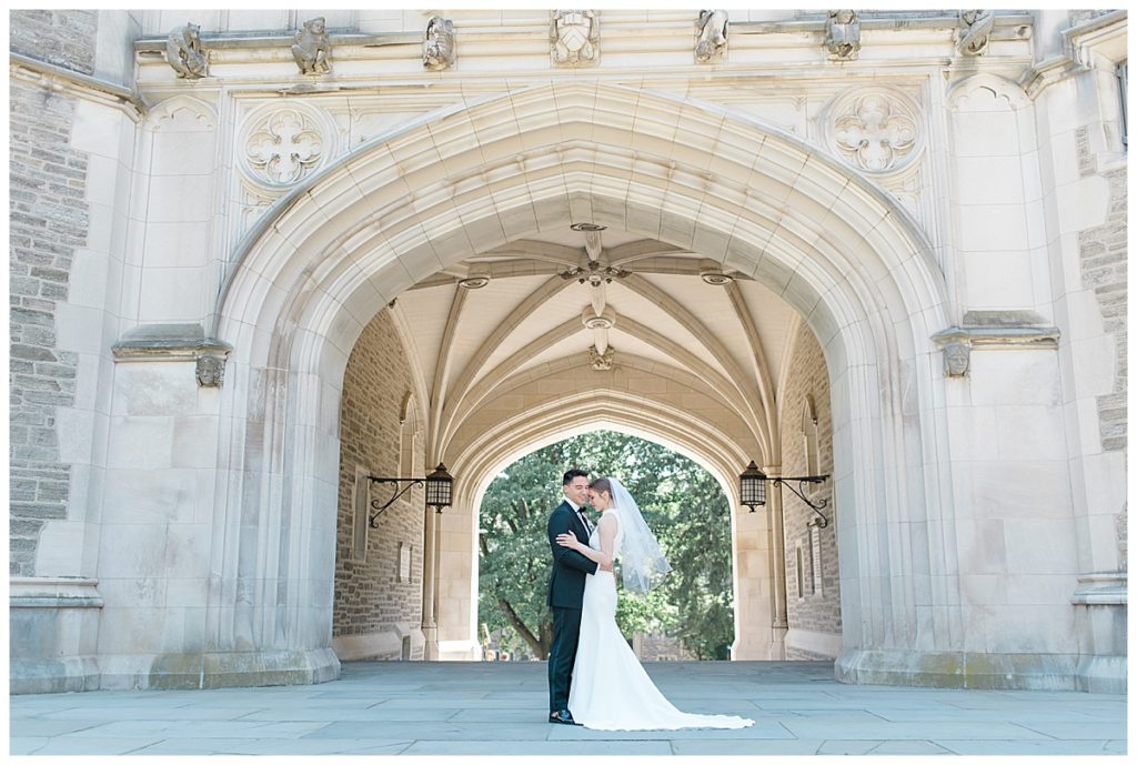 bride and groom framed by arches