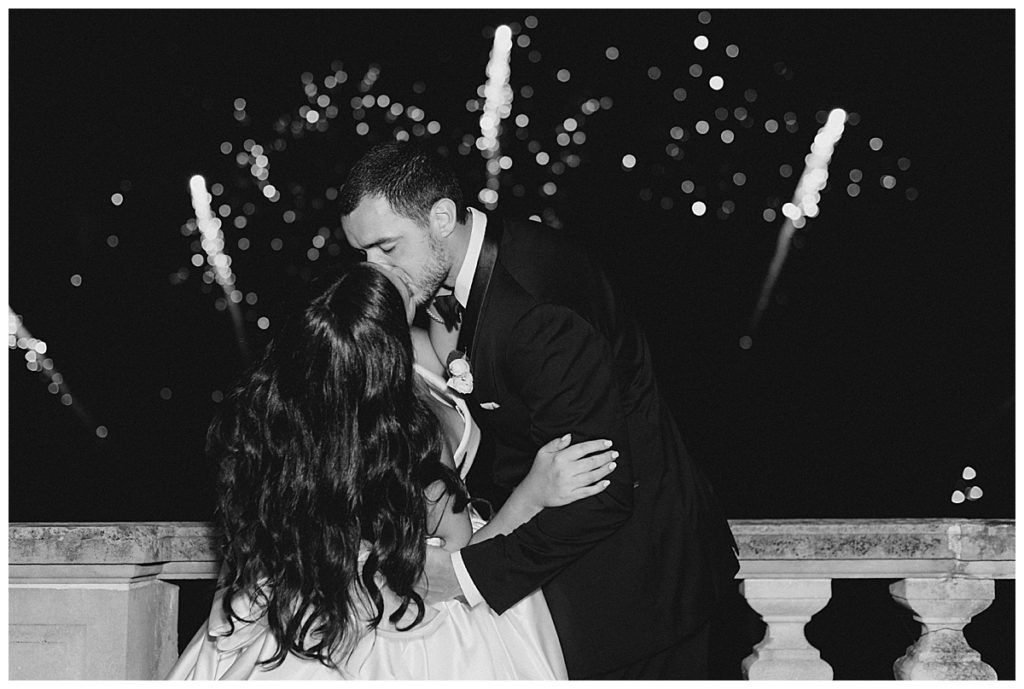 bride and groom kissing fireworks