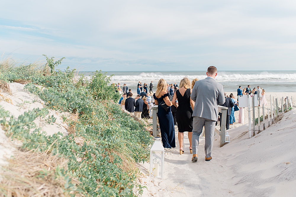 wedding guests walking down to beach